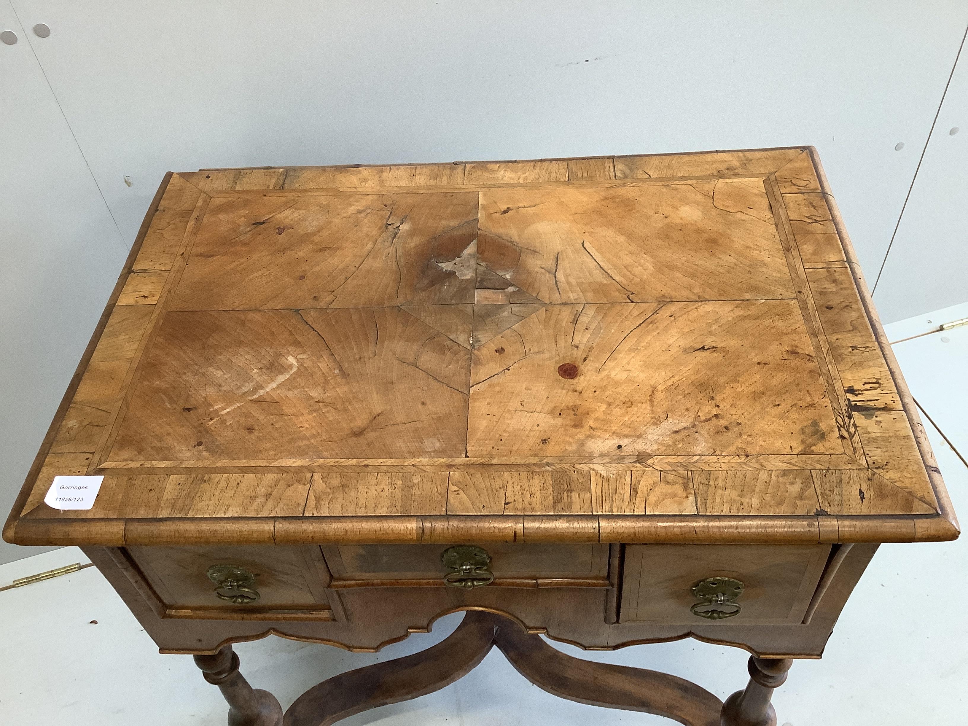A small 18th century style feather banded walnut lowboy, width 73cm, depth 49cm, height 74cm